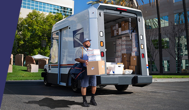 USPS mail truck with mail person outside of it delivering packages.