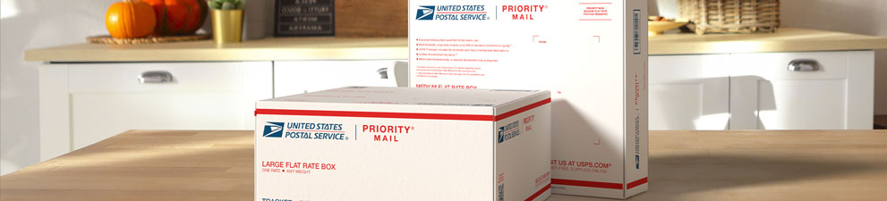 Two Priority Mail International® boxes sitting on a table.