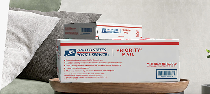 Domestic mail and shipping service product boxes sitting on a table.