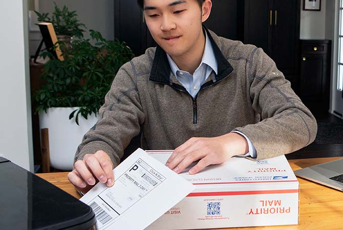 Person printing a Click-N-Ship label for a Priority Mail package.