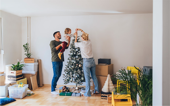 A family decorating a Christmas tree together.