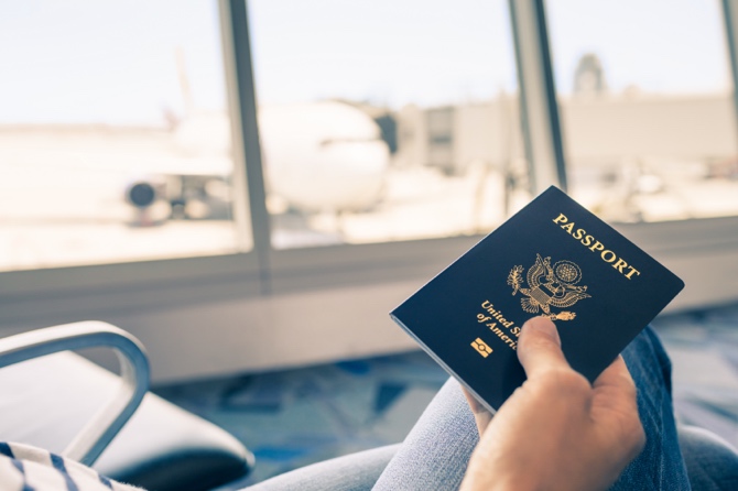 A passport being held by a person at an airport.