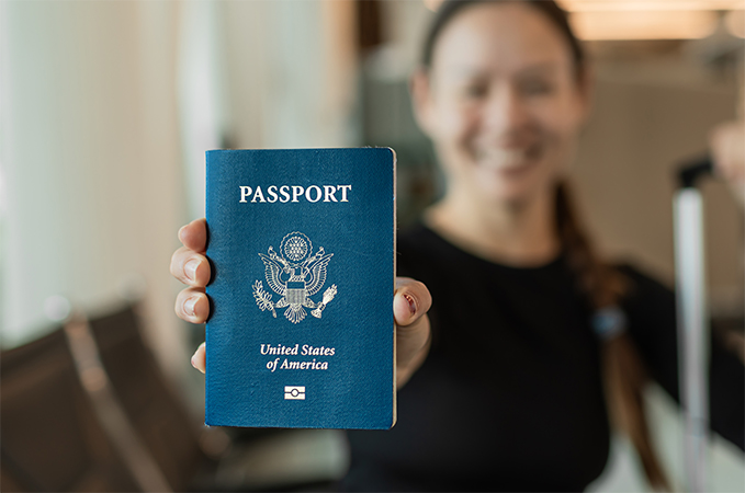 A person holding up a passport.