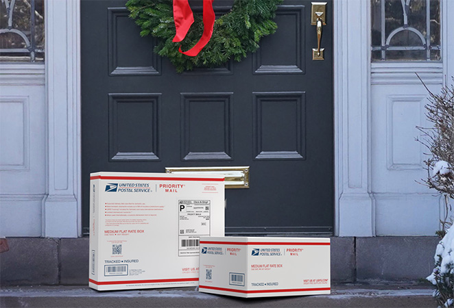 Priority Mail boxes on a house porch awaiting pickup.