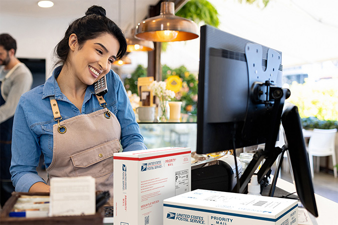 Small Business owner preparing to ship Priority Mail packages.