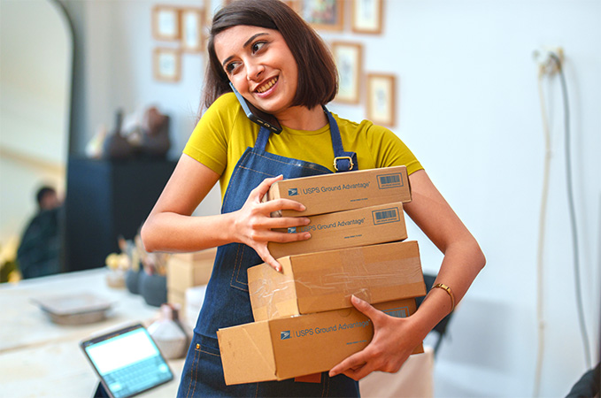 Small Business owner preparing to ship Priority Mail packages.