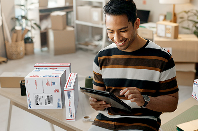 Small Business owner preparing to ship Priority Mail packages.