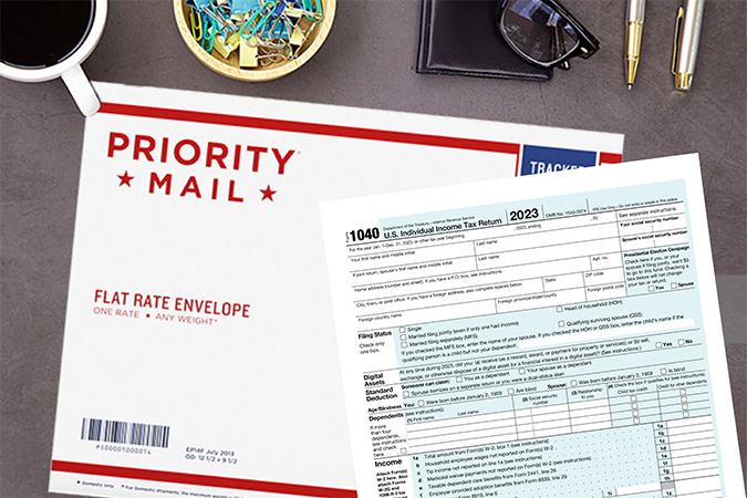 An IRS form 1040 and USPS Priority Mail envelope on a desk.