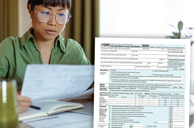 An IRS form 1040 on a desk being filled out.