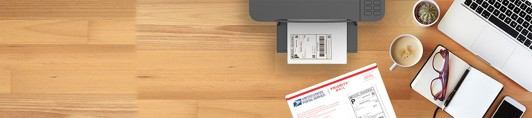 A shipping label on a printer and a Priority Mail shipping box sitting on a desk.